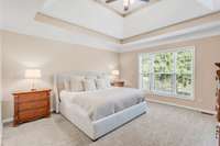 Unwind in this bright, freshly painted primary suite located on the main level and overlooking the backyard.