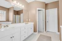 The primary bathroom is complete with double vanities, ample storage and a walk-in closet.