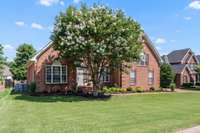 A stunning crepe myrtle anchors the front yard.