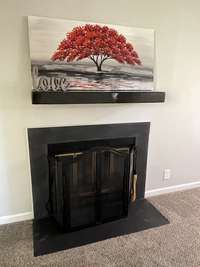 Living Room has 3 large Windows for Natural Light and Fireplace is wood-burning for cozy evenings or lazy mornings.