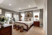 ***Photo is taken from a previous Eastfield model home in another community***  The Owner's Bedroom measures 15' x 14' and includes a tray ceiling. The Owner's Bath has been upgraded to include a tiled garden and shower with bench!