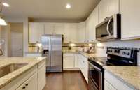 ***Photo is taken from a previous Eastfield model home in another community***  The gourmet Kitchen in Millstone will include built-in appliances, quartz countertops and upgraded cabinetry! This picture doesn't do our Kitchen justice.