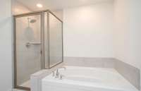 The Owner's Bathroom includes a tiled garden tub and shower.