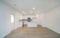 Located right off of the Kitchen is a Dining Room that is designed to comfortably fit an 8-person table with ease.
