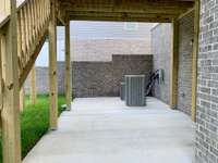 Walkout Basement leads to a Covered Patio with a brick privacy wall.