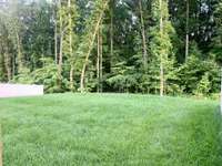 Backyard features a private wooded view.