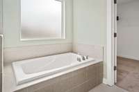 Picture of model home.  Colors and selections may vary.  Picture showing the optional Tile shower and tub that can be built on this home.