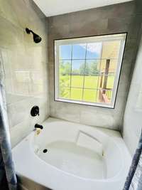 Nice garden tub and shower with tile surround in bath #2