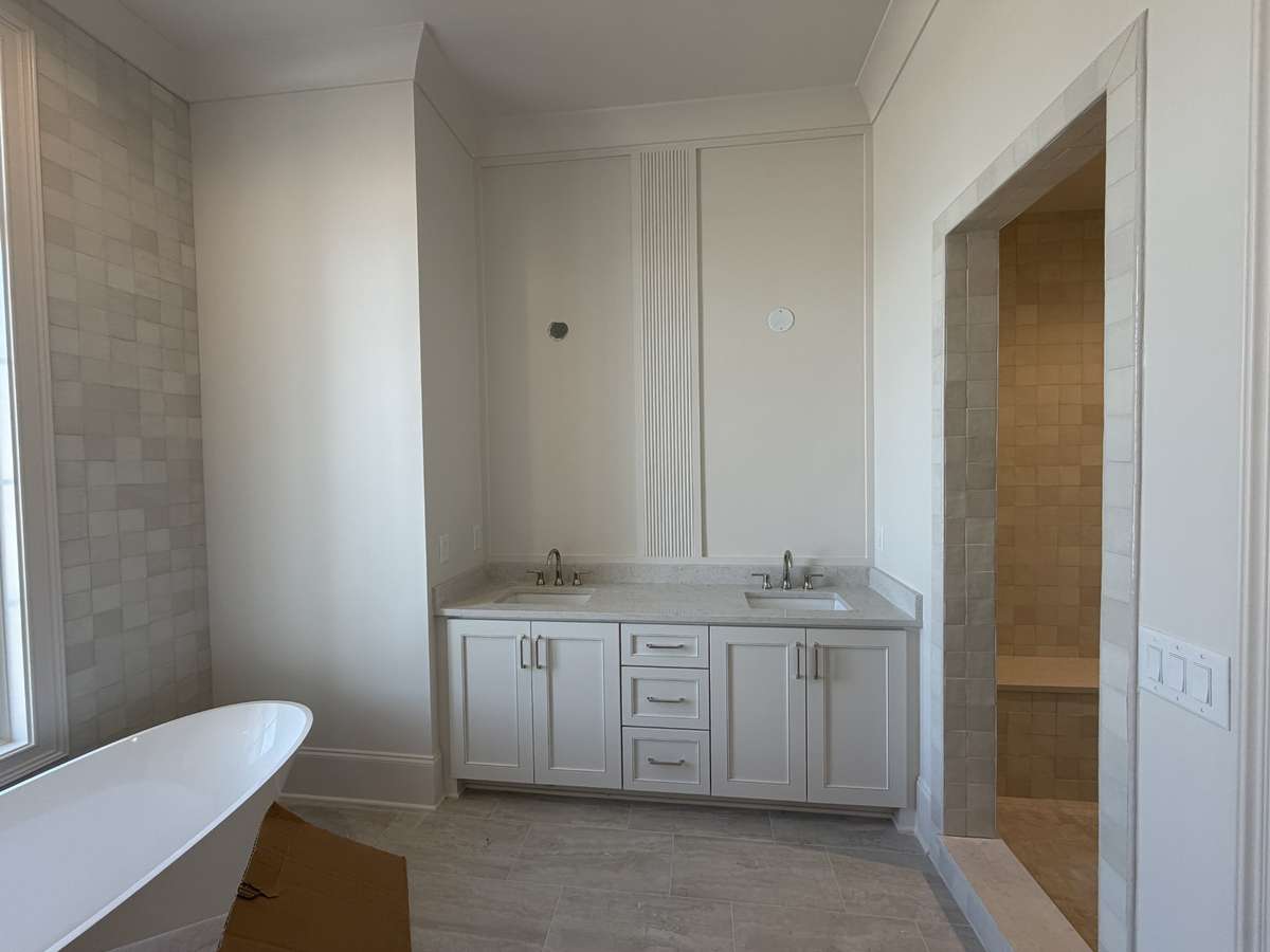 Guest Bathroom with separate sinks, full standing shower, and soaking tub.

*This home is under construction. Photo updated 3/20/26