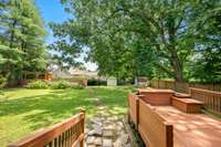 Steps leading from back deck to large back yard and above-ground pool