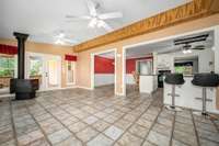 Florida sunroom with wood-burning stove. The door in the background leads to 3-tier covered deck