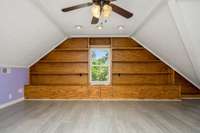 Another view of large second floor bedroom with built in shelving