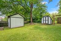 Two storage sheds that convey with property