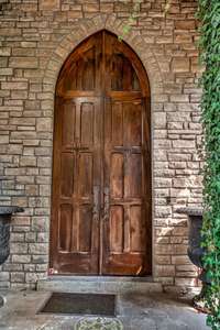 As you approach the massive Gothic doors and entrance , limestone paves the path beneath your feet and to either side of you