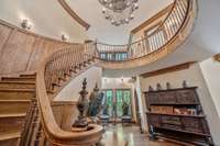 This wood staircase is an architectural masterpiece crafted from richly stained hardwood