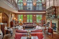 Along one of the walls in the library, a series of tall, arched windows give you breathtaking views of mature trees that burst  brilliant shades of gold each Fall