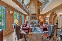 This two story library framed by pointed Gothic arches, rich wood walls with a massive fireplace anchoring the space is a show stopper. The arched bookshelves line much of the walls on both levels while the balcony above wraps the perimeter.