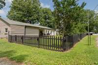 Front, sides and back are completed fenced in with a HUGE parking area outside of the fence on the left side of home.