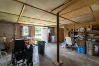 Enclosed former garage now is heated and cooled storage space of over 500'
