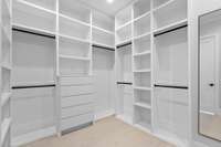 Connected Primary Walk In Closet Includes Floor to Ceiling Shelving and a Built In Full Length Mirror