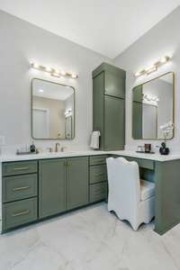 One Side of Bathroom Includes Single Vanity, Makeup Vanity, and Double Stack Linen Storage