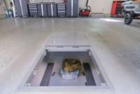 Secure in-ground storm shelter in the garage, providing peace of mind and safety for your family during severe weather