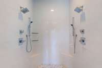 Spacious walk-in shower with dual showerheads.
