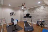 Dedicated exercise room with stylish accent wall, recessed lighting, and space for your favorite workout equipment, and full closet.  This could be bedroom 6.