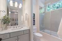 Ensuite bathroom 3, offering ample storage, and a sleek glass shower for convenience and style.