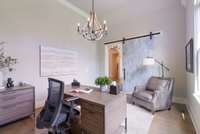 Cozy study or reading nook with a sliding barn door for added privacy and comfort.
