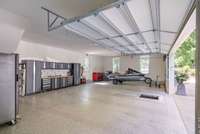 Immaculate garage with epoxy floors, built-in storage, and plenty of space for vehicles, tools, and hobbies.