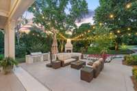 Enjoy peaceful mornings or lively afternoons in this spacious backyard retreat, complete with shaded seating and lush, mature trees.