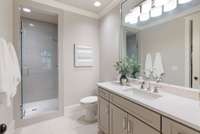 Elegant en suite bathroom 5 with walk-in shower and modern finishes for a spa-like experience.