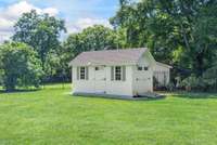 Outdoor shed—perfect for keeping all your gardening tools and backyard essentials organized and close at hand.