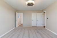 Primary bedroom with en suite bath and walk-in closet.