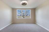 Primary bedroom with low profile LED lighted ceiling fan.