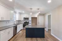 Completely renovated Kitchen with new cabinets, tile backsplash, quartz countertops and stainless steel appliances.