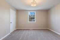 3rd bedroom located on the back side of the home overlooking the back lawn.
