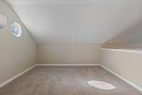 Smaller area of upstairs bonus room with octagon window. This would make a quiet and private office.
