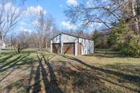 Detached 2 car garage/workshop with electricity. Back yard continues past garage.