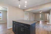 Kitchen island with drawers and cabinets for extra storage. Formal dining room is conventiently located to the right.