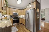Kitchen With Granite Counters And Stainless Microwave, Stove And Dishwasher