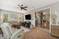 Sunroom With Tile Flooring And Access To Backyard Patio