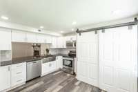 Pantry and washer/dryer hookup behind the barn doors