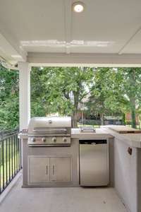 Built in Gas Grill on the back patio also has a mini fridge and a bar top for serving friends!