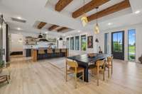 The interior is bathed in light, and the exposed beams add a rustic feel to this elegant home