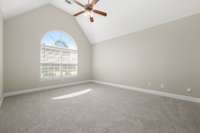First floor primary bedroom with vaulted ceiling