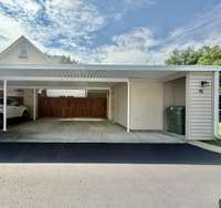 covered 2 car carport with storage closet