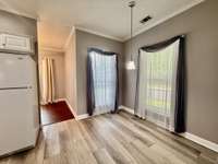 Large Eat in area with hanging pendent; Crown mold throughout the home;