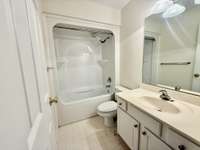 Full bath upstairs with tub/shower combo with custom vanity with marble top;